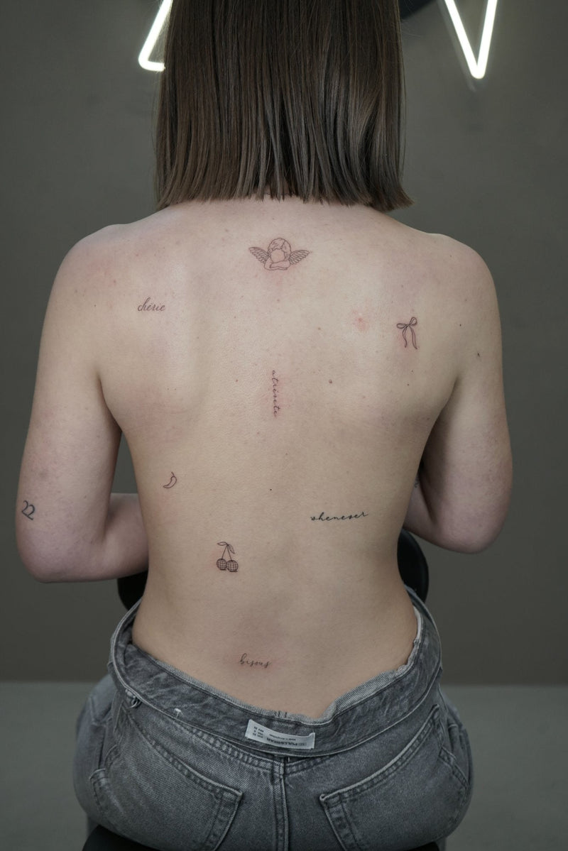 girl's back with fineline tattoo made by Picci