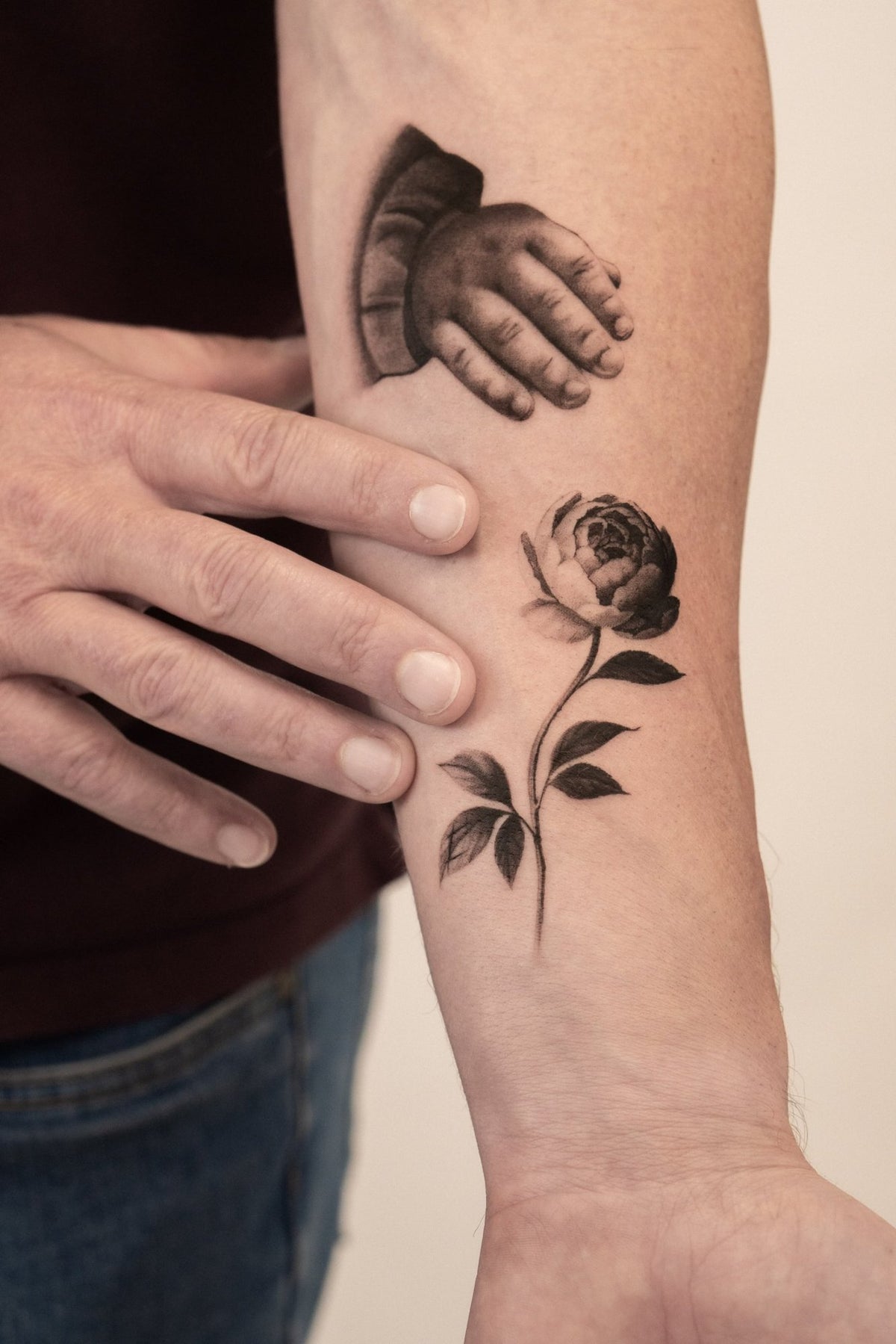 Microrealism tattoo of a child's hand and a peony by Fabio Pillon, The White Whale Tattoo Society, Milano