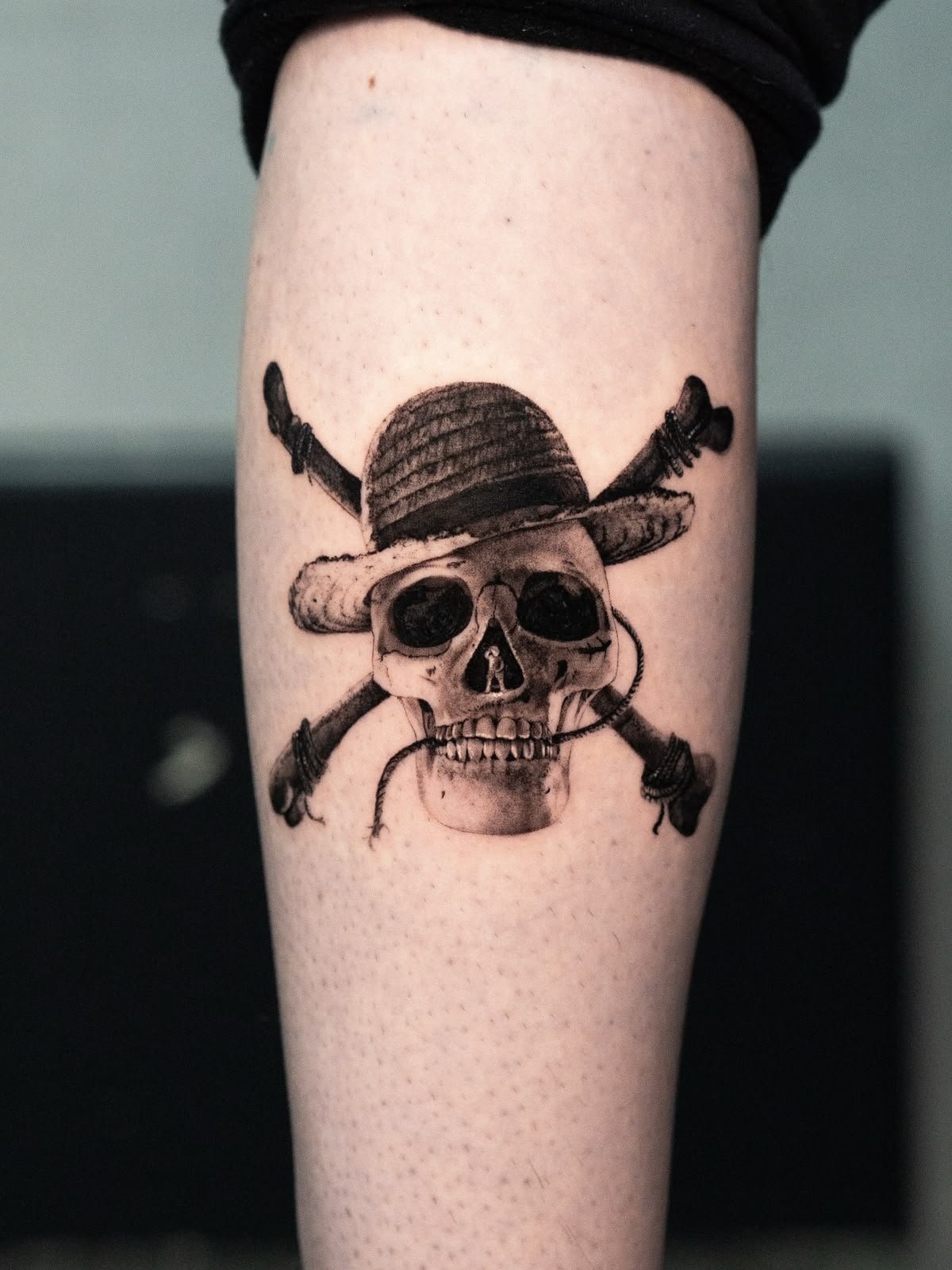 Black and Grey tattoo of a skull with a straw hat and crossed bones by Fabio Pillon, The White Whale Tattoo Society, Milano