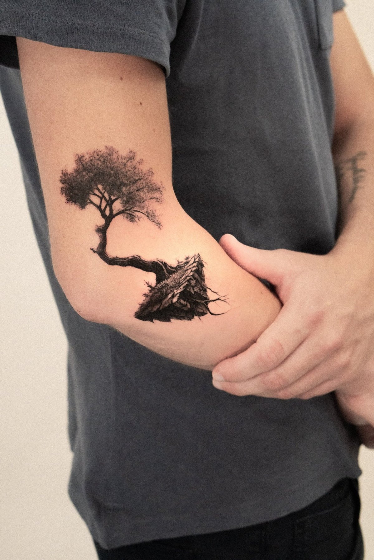 Realism tattoo of a tree growing from a rock by Fabio Pillon, The White Whale Tattoo Society, Milano